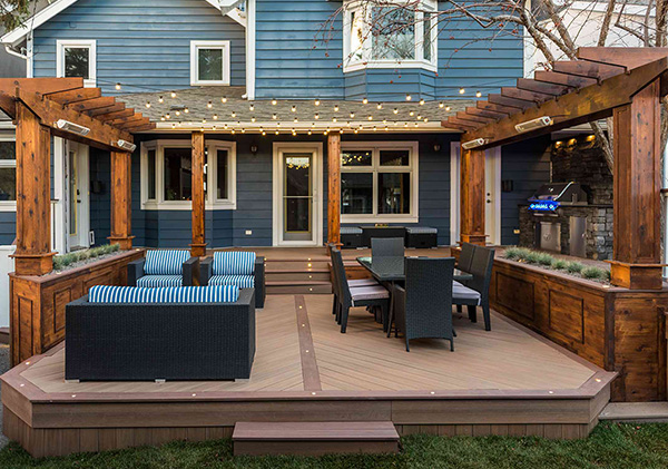 A Kensington, Calgary deck designed with extended roof structure, outdoor kitchen and gas fire pit.