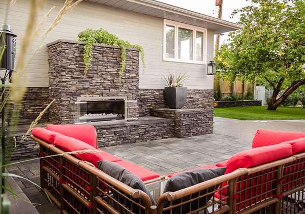 Maliby Road, Calgary backyard with patio and outdoor fireplace construction.